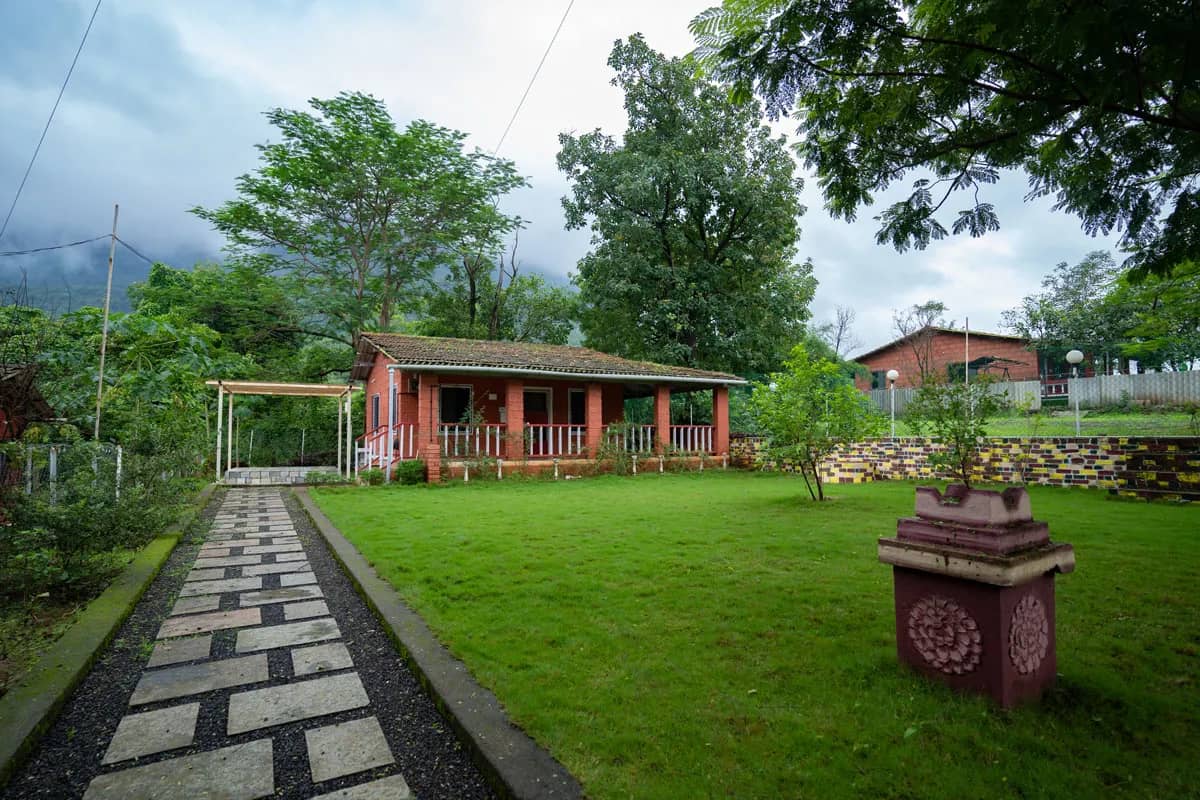 Reddish-brown brick cottage with a covered porch